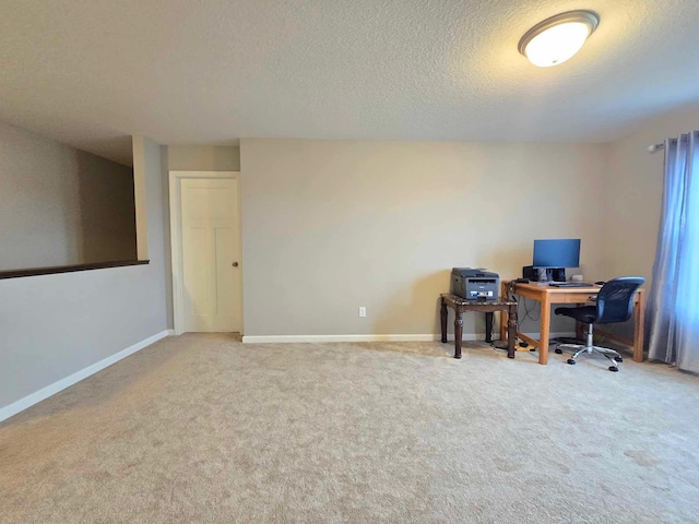 office area with carpet and a textured ceiling