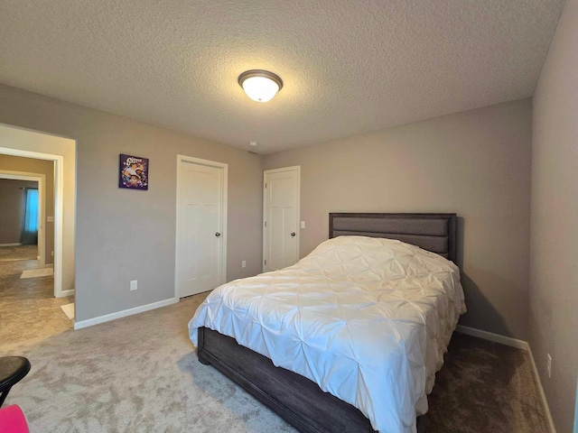 carpeted bedroom featuring a textured ceiling