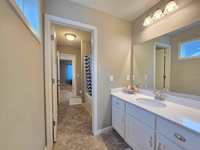 bathroom with vanity, shower / bath combination with curtain, and a textured ceiling