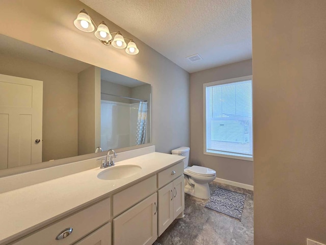 bathroom featuring vanity, toilet, a textured ceiling, and walk in shower