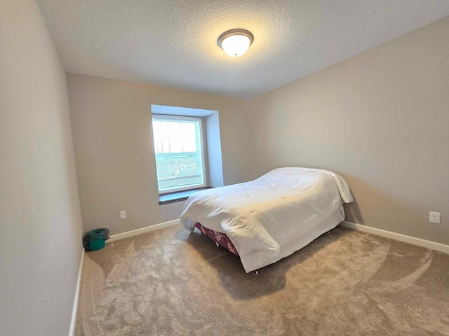 carpeted bedroom featuring a textured ceiling