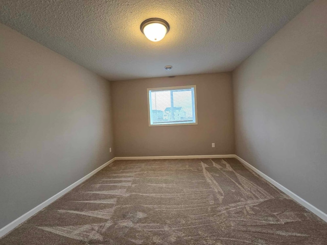 carpeted spare room featuring a textured ceiling