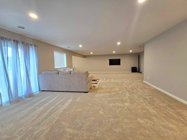 unfurnished living room with light colored carpet