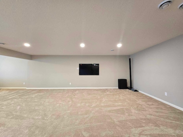 basement with light carpet and a textured ceiling