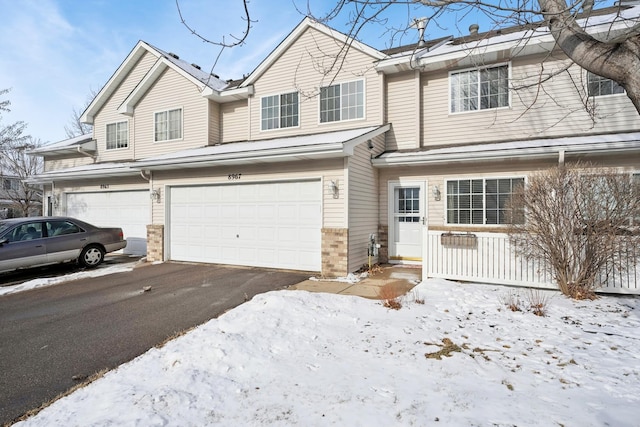 townhome / multi-family property featuring a garage