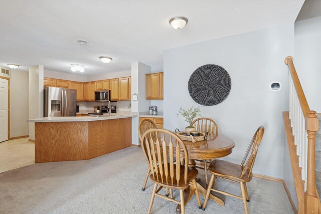 carpeted dining room featuring sink