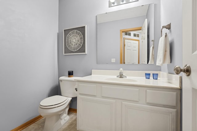 bathroom featuring toilet, vanity, and tile patterned flooring