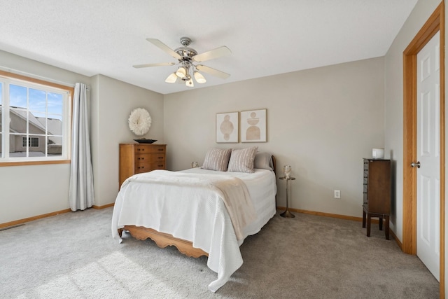 bedroom with ceiling fan and light colored carpet