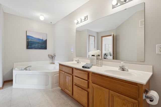 bathroom featuring a textured ceiling, tile patterned flooring, a tub to relax in, and vanity