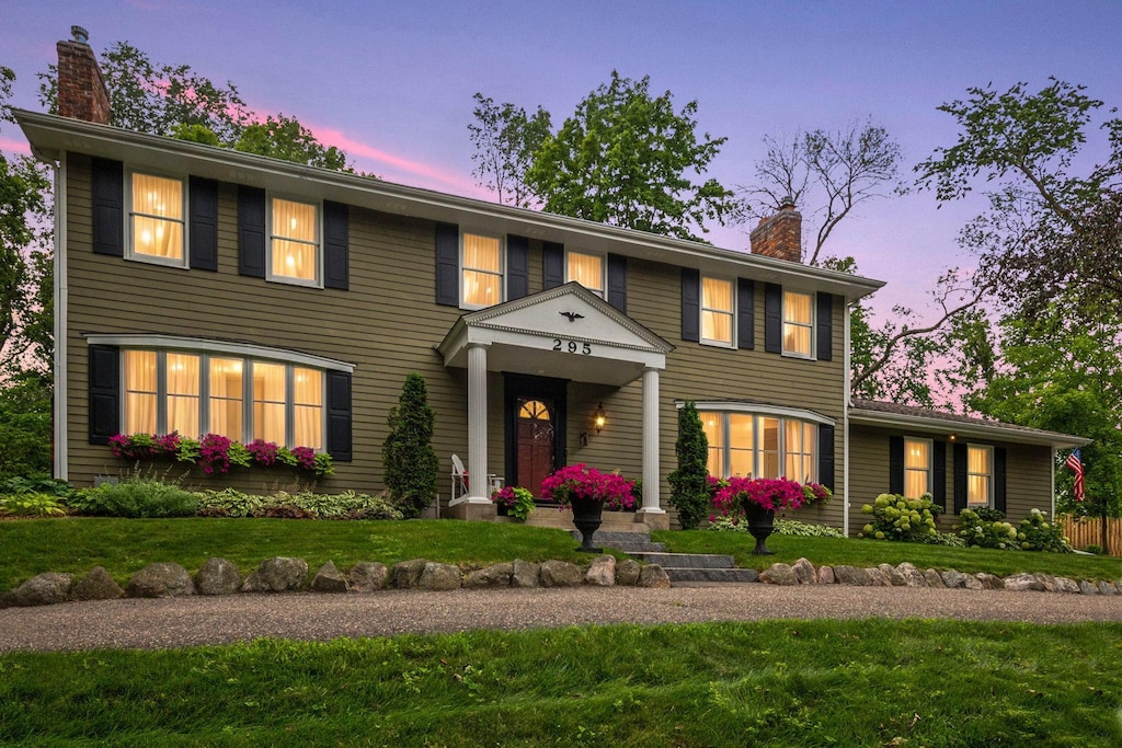 colonial inspired home with a yard