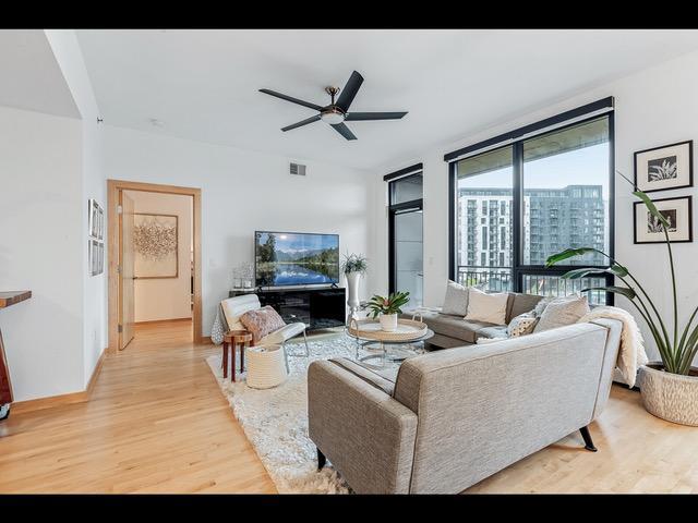 living room featuring ceiling fan and light hardwood / wood-style flooring