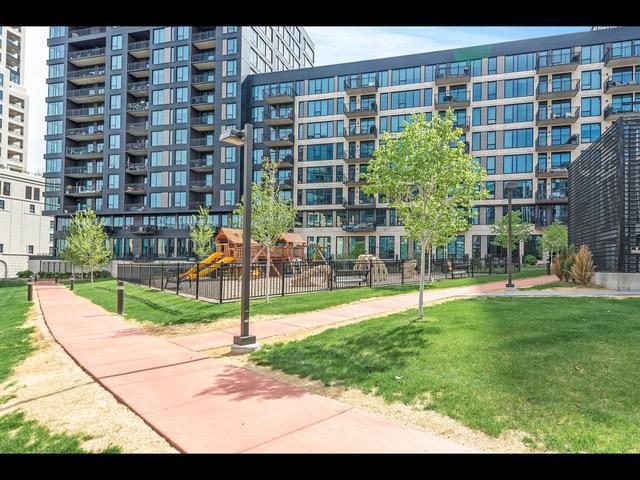 surrounding community featuring a playground and a lawn