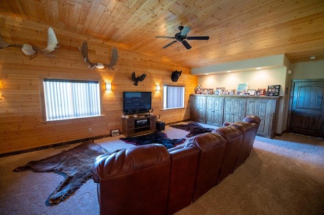 carpeted living room with ceiling fan, wood walls, and wood ceiling