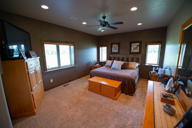 bedroom with light carpet and ceiling fan