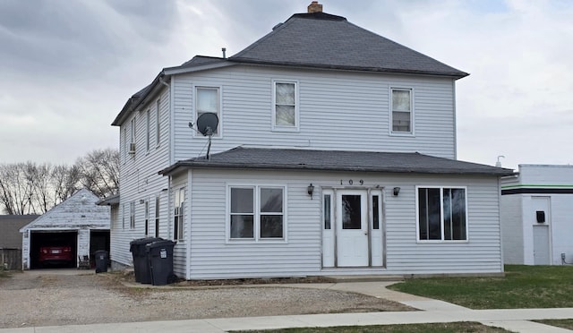 109 Greeley St W, Marshall, MN 56258 - view of front facade featuring an outbuilding, a chimney, a detached garage, and a shingled roof