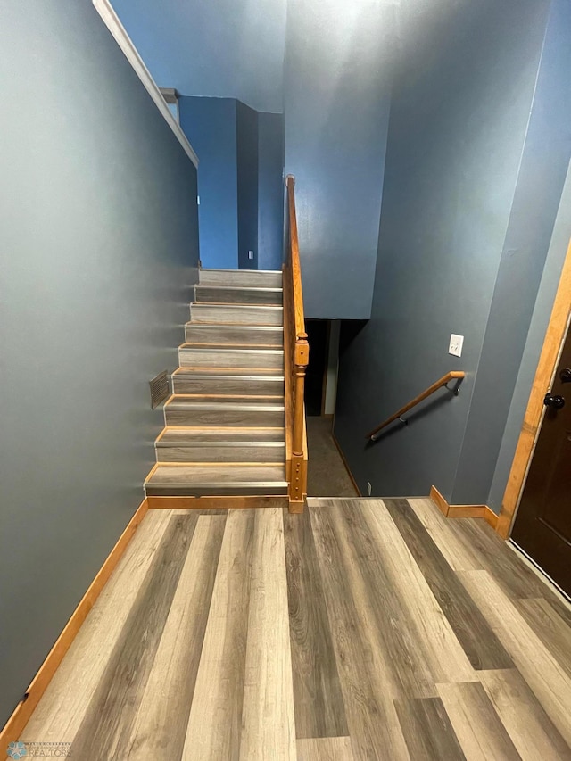 stairway with wood-type flooring