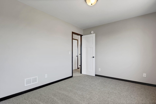 unfurnished room featuring light colored carpet