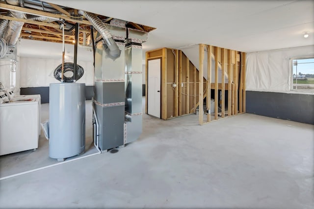 basement with heating unit, water heater, and separate washer and dryer