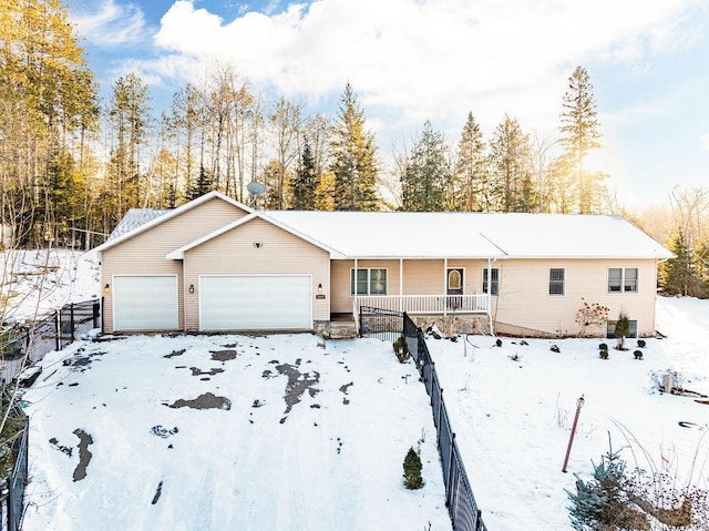 single story home featuring covered porch and a garage