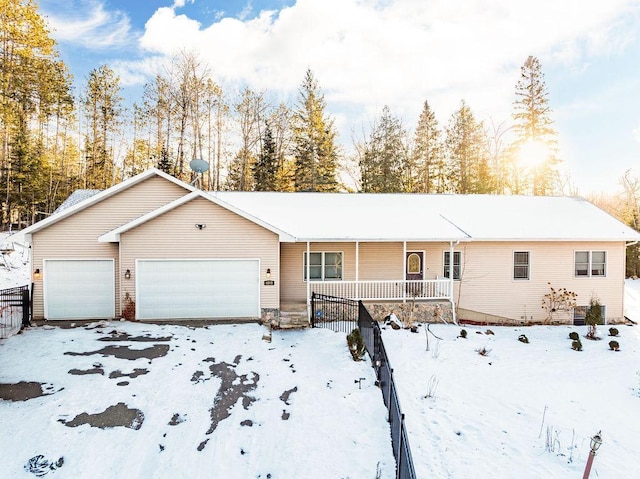 single story home featuring a porch and a garage