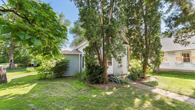205 Broadway St SE, Isanti, MN 55040 - view of side of property featuring a lawn