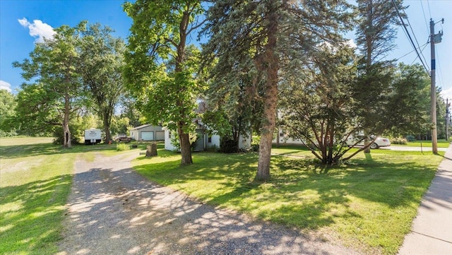 205 Broadway St SE, Isanti, MN 55040 - obstructed view of property featuring a front lawn and an outbuilding