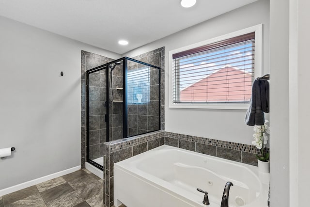 bathroom featuring independent shower and bath