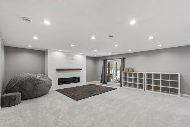 carpeted living room with a fireplace