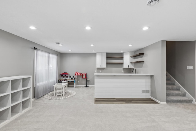 carpeted living room featuring sink