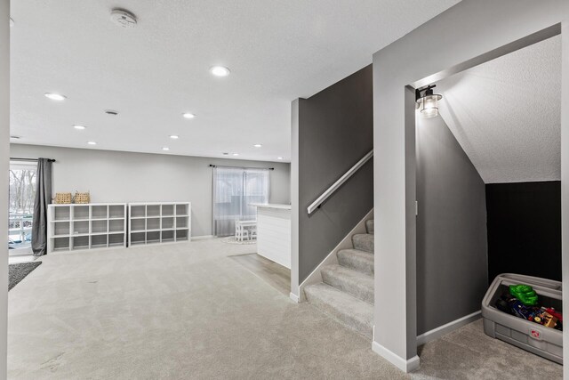 basement featuring light colored carpet