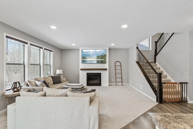 living room featuring hardwood / wood-style floors and a textured ceiling