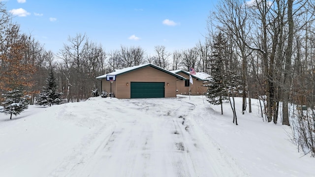 view of snowy exterior featuring a garage