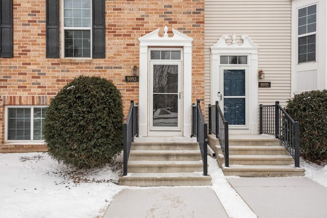 view of snow covered property entrance