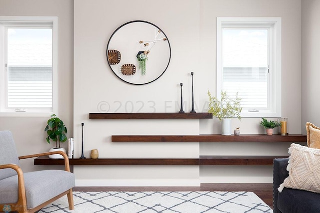 sitting room with a healthy amount of sunlight and hardwood / wood-style flooring