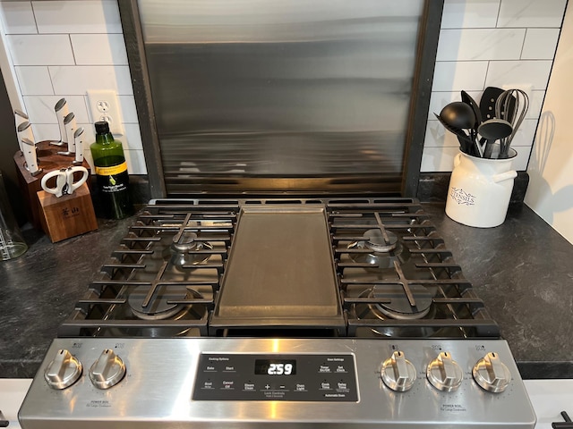 details featuring backsplash and stove