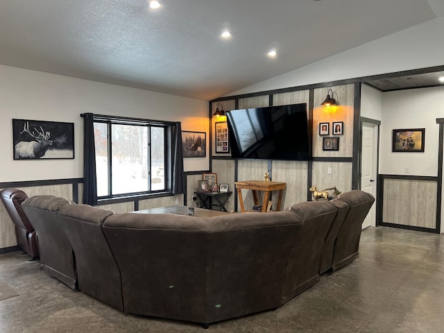 living room with concrete flooring, a textured ceiling, and lofted ceiling