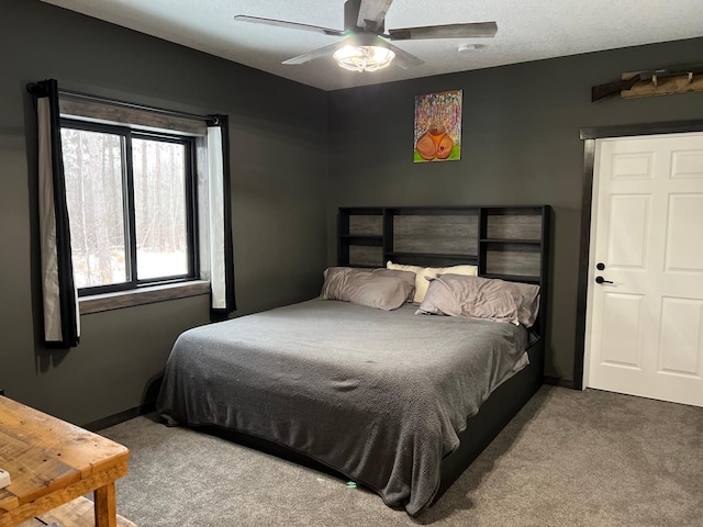 bedroom with carpet flooring, ceiling fan, and a textured ceiling