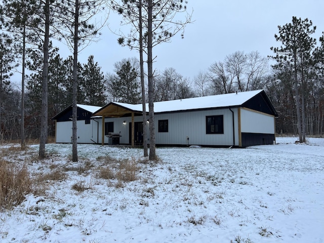 view of snow covered rear of property