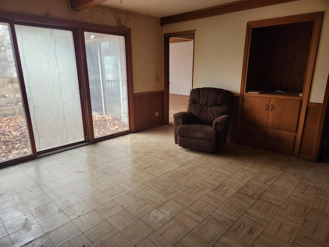 sitting room featuring wooden walls