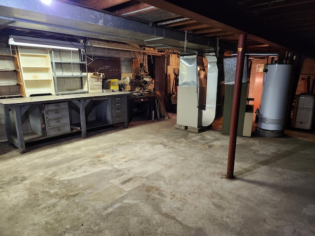 basement featuring heating unit, a workshop area, and gas water heater