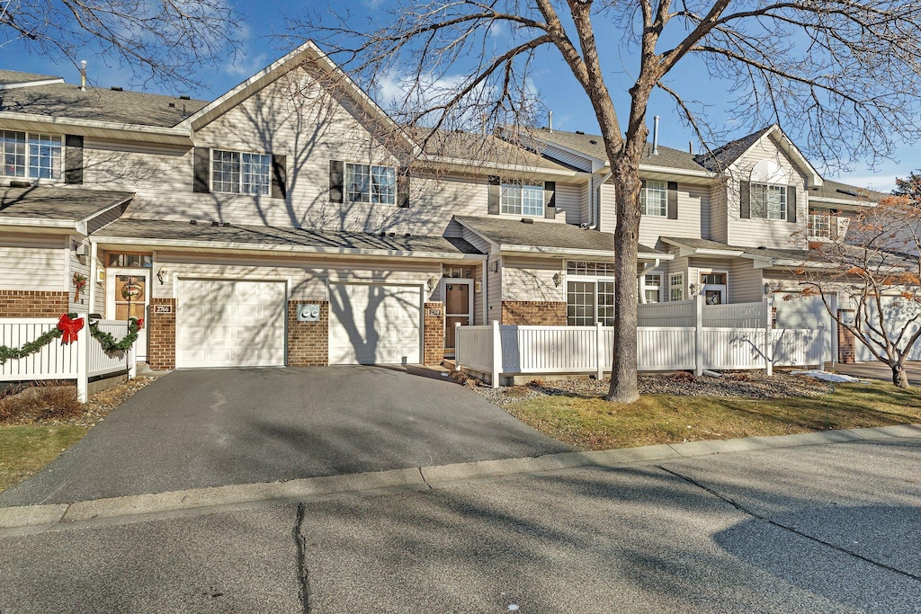 multi unit property featuring a garage