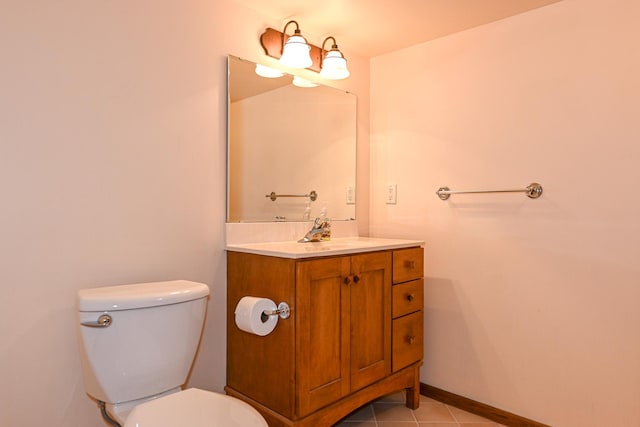 bathroom with tile patterned flooring, vanity, and toilet