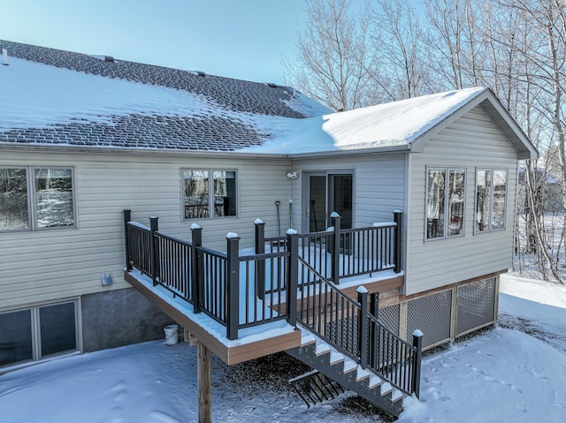 view of snow covered rear of property