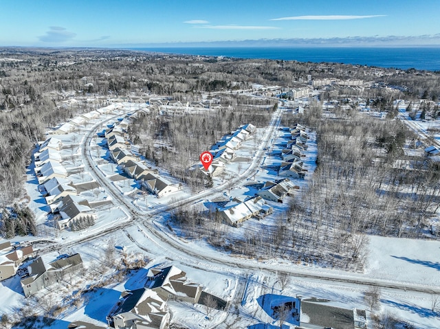 snowy aerial view featuring a water view