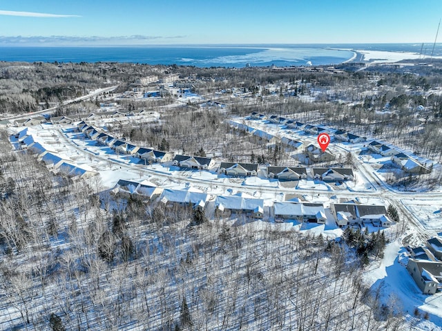 snowy aerial view with a water view