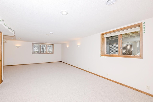basement with recessed lighting, light carpet, and baseboards