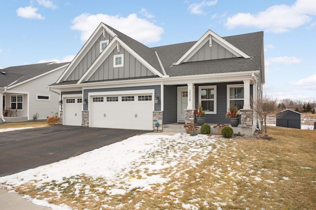 craftsman house with a garage and covered porch