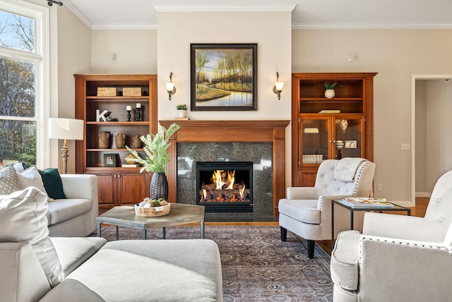 living area with a high end fireplace, dark hardwood / wood-style floors, built in features, and ornamental molding