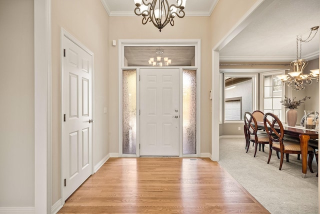 entryway featuring light wood-type flooring, crown molding, and a notable chandelier