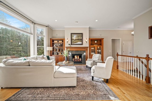 living room with ornamental molding and light wood-type flooring